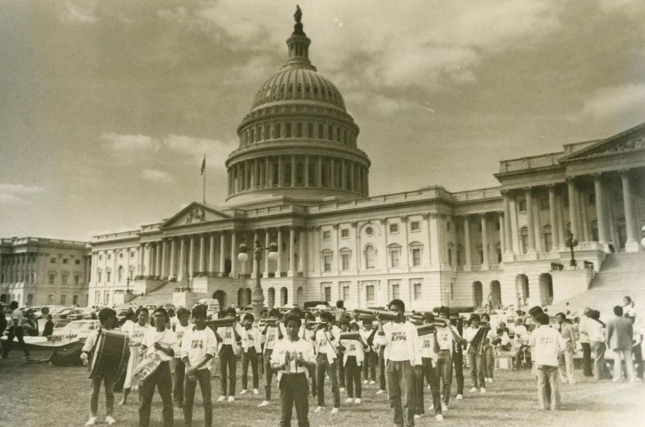 Filipino youth marching bank standing in front of the U.S. Capital
